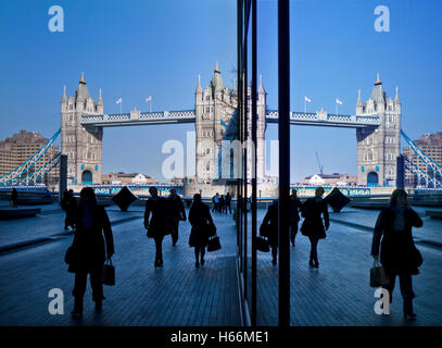Tower Bridge viewed from Queen's Walk with office commuters in silhouette Southwark London UK Stock Photo