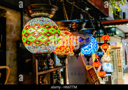 Glass lampshades hanging from the roof of a shop in Fethiye Market, Turkey Stock Photo