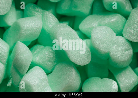 pieces of green styrofoam in carton box background. Stock Photo