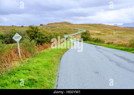 A passing place sign on a narrow single track road as it winds through the beautiful barren landscape of Isle of Skye Scotland Stock Photo