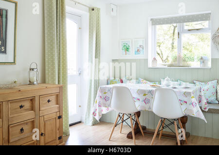 Afternoon tea set on a table in a light & fresh dining area in a typical UK home Stock Photo
