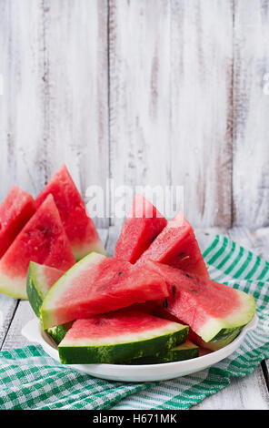 Slices of juicy and tasty watermelon on a white plate. Stock Photo