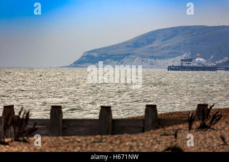 Eastbourne Pier and Beachy Head in the distance, with old groyne in foreground. East Sussex on a autumn evening Stock Photo