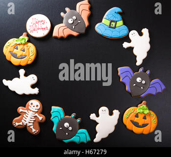 Funny delicious ginger biscuits for Halloween on the dark background. Stock Photo