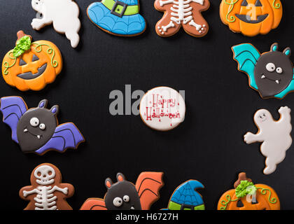 Funny delicious ginger biscuits for Halloween on the dark background. Stock Photo