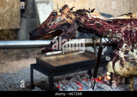 Taurus bull being cooked on a open fire. Stock Photo