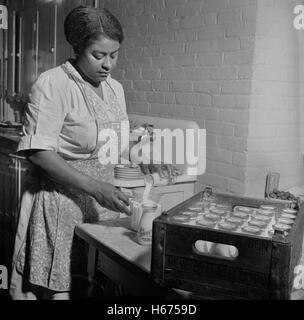 Dietician Preparing Milk for Lunch Period at Child Care Center, New Britain, Connecticut, USA, Gordon Parks for Office of War Information, June 1943 Stock Photo