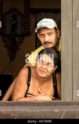 Portrait of middle-aged couple in window, Havana, Cuba. Stock Photo