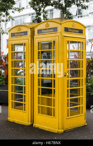 Two yellow telephone kiosks situated in St. Peter Port, Guernsey, Channel Islands. Stock Photo