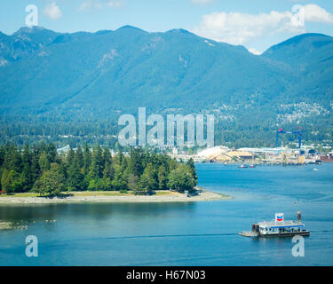 Elevated view: Coal Harbour, the floating Chevron fuel station, Stanley Park, Vancouver Harbour, and Grouse Mountain. Vancouver. Stock Photo