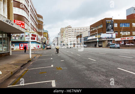 Many unknown people on quiet overcast early morning on Anton Lembede Street in city center Stock Photo