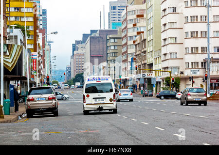 Many unknown people and motor vehicles on quiet overcast early morning on Anton Lembede Street in city center Stock Photo