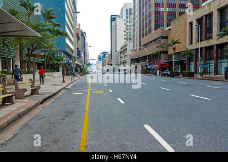 Many unknown people on quiet overcast early morning on Anton Lembede Street in city center Stock Photo