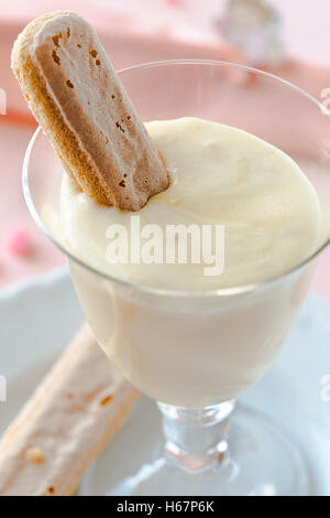 Zabaione, Italian dessert made of egg yolks, sugar, and Marsala wine served with sponge finger biscuits Stock Photo