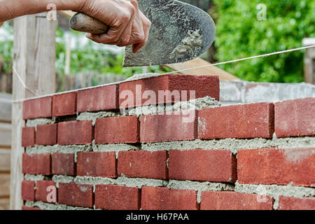 Bricklayer on construction site Stock Photo