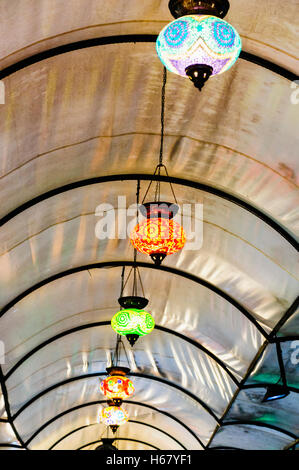 Glass lampshades hanging from the roof of Fethiye Market, Turkey Stock Photo