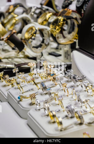 Diamond rings and bracelets on display in a jeweller's window. Stock Photo