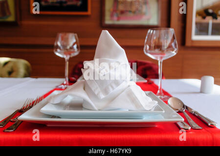 Folded napkin and place settings in a fine dining restaurant Stock Photo