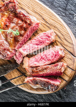 Medium Ribeye steak on the wooden tray. Stock Photo