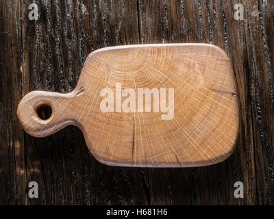 Empty chopping wooden board on the wooden table. Stock Photo