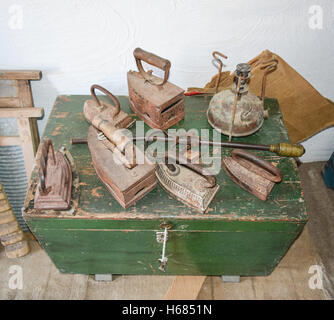 Ancient irons on a timber floor. Reconstruction of life of Cossacks of Kuban. Stock Photo