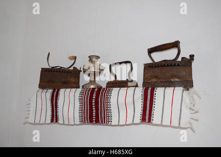 Ancient irons on a timber floor. Reconstruction of life of Cossacks of Kuban. Stock Photo