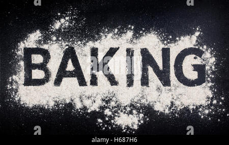 Word baking written in white flour on dark table Stock Photo