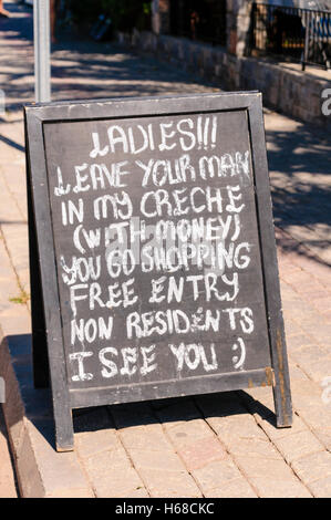 Blackboard outside a Turkish hotel bar advising ladies to leave your man in my creche (bar) to go shopping. Stock Photo