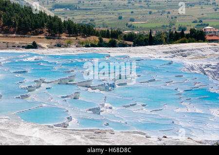 Terraced travertines at the thermal springs pools with bright blue water at Pamakkule, Turkey Stock Photo