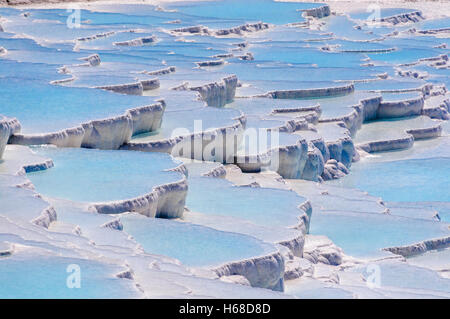 Terraced travertines at the thermal springs pools with bright blue water at Pamakkule, Turkey Stock Photo