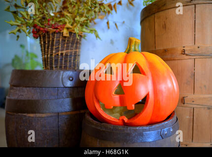 Halloween pumpkin head jack lantern on wooden barrel Stock Photo