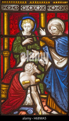 ROME, ITALY - MARCH 9. 2016: The Saints Peter and John Healing the Lame Man on the stained glass of All Saints' Anglican Church Stock Photo