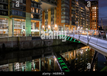 Illuminated footbridge crossing the River Irwell joining Spinningfields ...