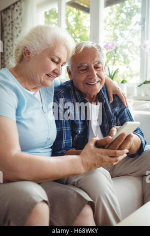Senior couple using mobile phone Stock Photo
