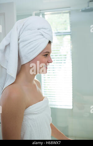 Woman in a bathrobe with a towel on her head Stock Photo