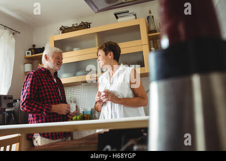 Senior couple interacting while having coffee Stock Photo