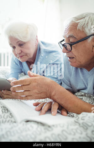 Senior couple interacting with each other on bed Stock Photo