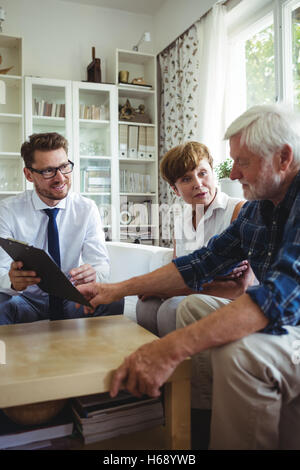 Senior couple planning their investments with financial advisor Stock Photo