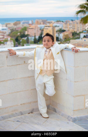 Young First Communion boy leaning on a big tree Stock Photo Alamy