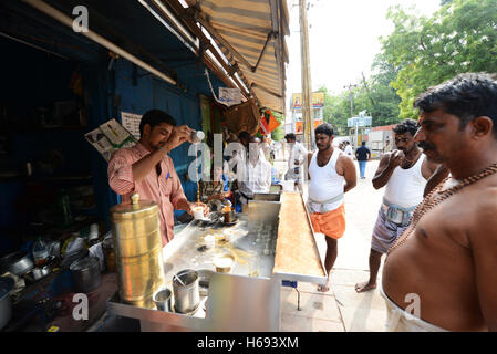 A Chai Wallah preparing traditional Indian Chai ( milk tea ) in Madurai, India. Stock Photo