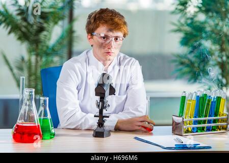 Young crazy chemist working in the lab Stock Photo