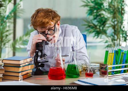 Young crazy chemist working in the lab Stock Photo