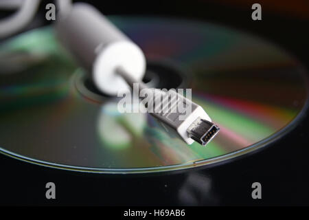 Computer media devices. Compact disc and usb cable. Stock Photo