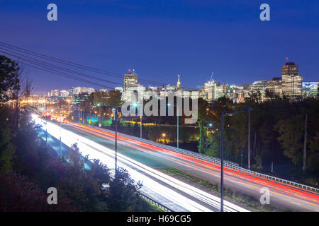 The Hull region of Gatineau skyline at dusk with Boulevard des Allumettières (Highway 148) in the foreground. Quebec, Canada. Stock Photo