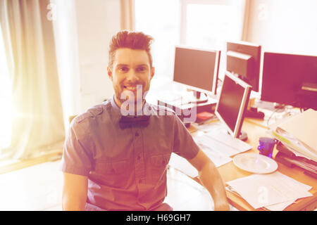 happy creative male office worker with computers Stock Photo