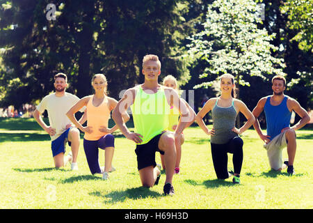 group of friends or sportsmen exercising outdoors Stock Photo