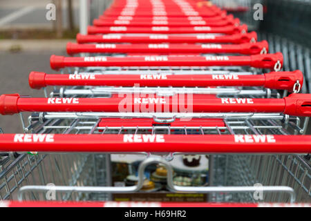 HANNOVER / GERMANY - OCTOBER 18, 2016: Shopping carts of the german supermarket chain, Rewe stands together in a row on parking Stock Photo