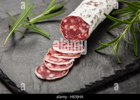 Salami on dark background Stock Photo