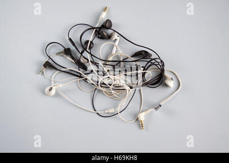 A tangle of in ear headphones Stock Photo