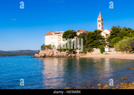 Dominican monastery in Bol, built in 15th century, now partially converted to a hotel with pebbled beaches Stock Photo